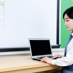 A professional Korean language teacher, fully clothed in a modest, contemporary business casual outfit, sitting at a clean desk in a modern, bright classroom. She is focused on a laptop screen displaying Korean lesson plans and integrating elements of K-pop or K-drama, with traditional Korean cultural items subtly arranged in the background. The scene emphasizes innovative teaching and thoughtful content preparation.
    *   safe for work, appropriate content, fully clothed, professional, perfect anatomy, correct proportions, natural pose, well-formed hands, proper finger count, natural body proportions, professional photography, high quality, realistic.